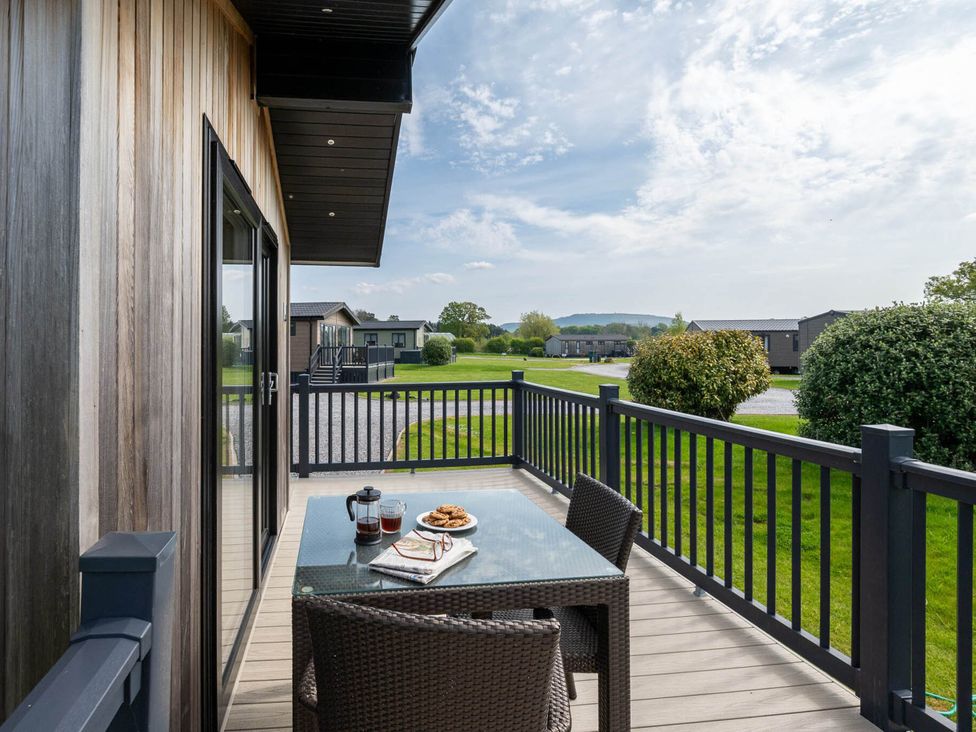 An outdoor area with a table and chairs at Stokesley in Great Ayton