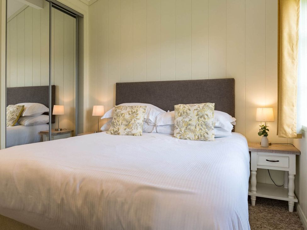 A bedroom with a bed and bedside lamp at Stokesley in Great Ayton