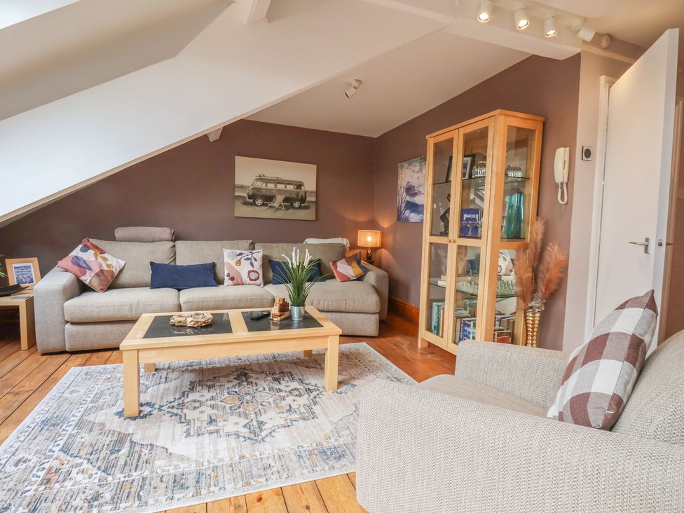 A living room with a sofa and armchair at The Studio on the Crescent in Whitby