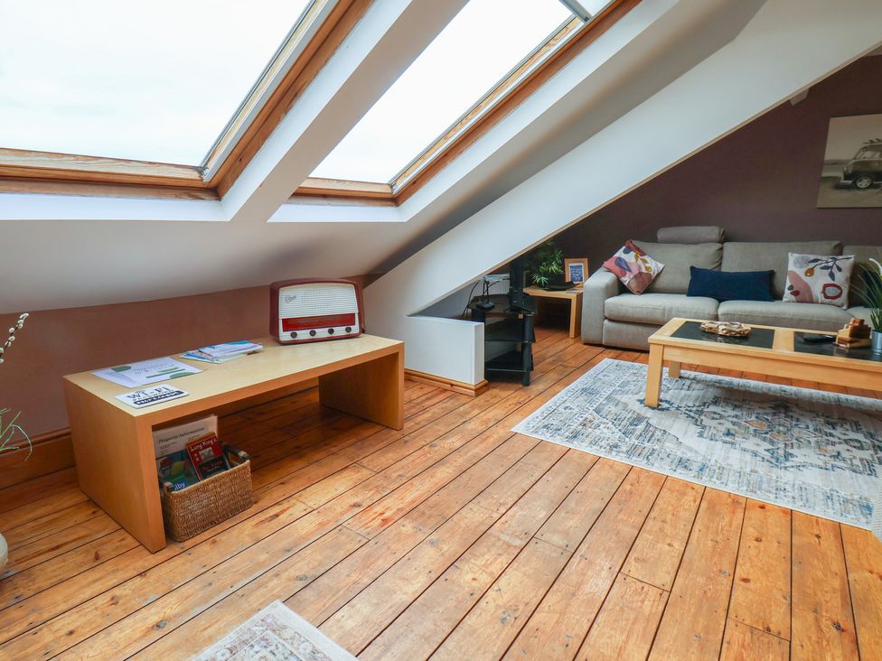 A living room with a sofa and skylights at The Studio on the Crescent in Whitby