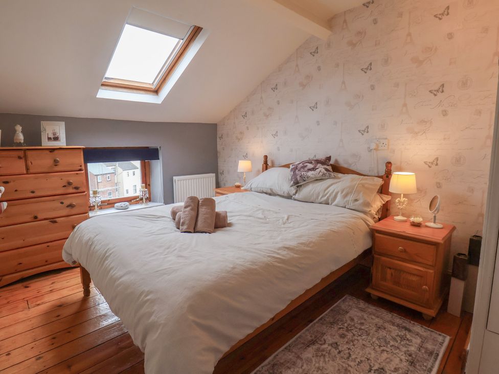 A bedroom with a bed and dresser at The Studio on the Crescent Whitby