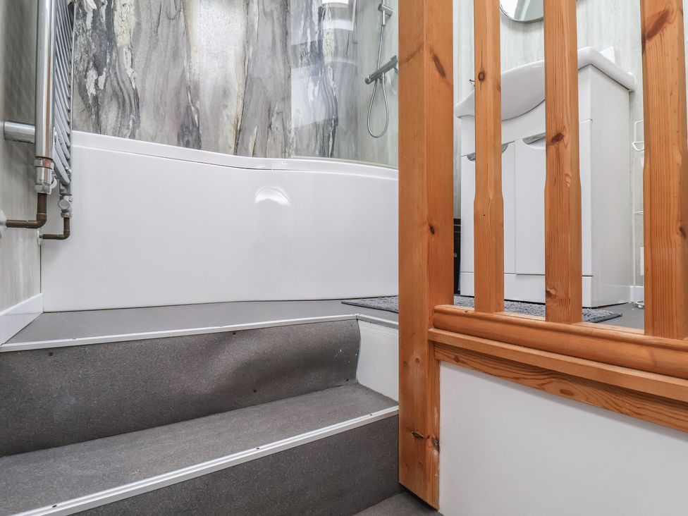 A bathroom with a bathtub and sink at The Studio on the Crescent Whitby
