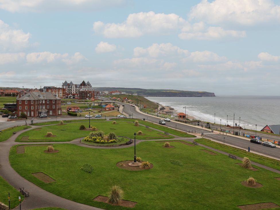 A view of the sea and buildings from a park at The Studio on the Crescent Whitby