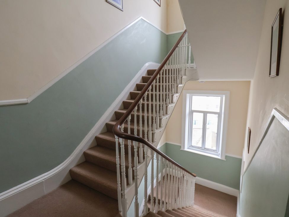 A staircase with a window and frames at The Studio on the Crescent in Whitby