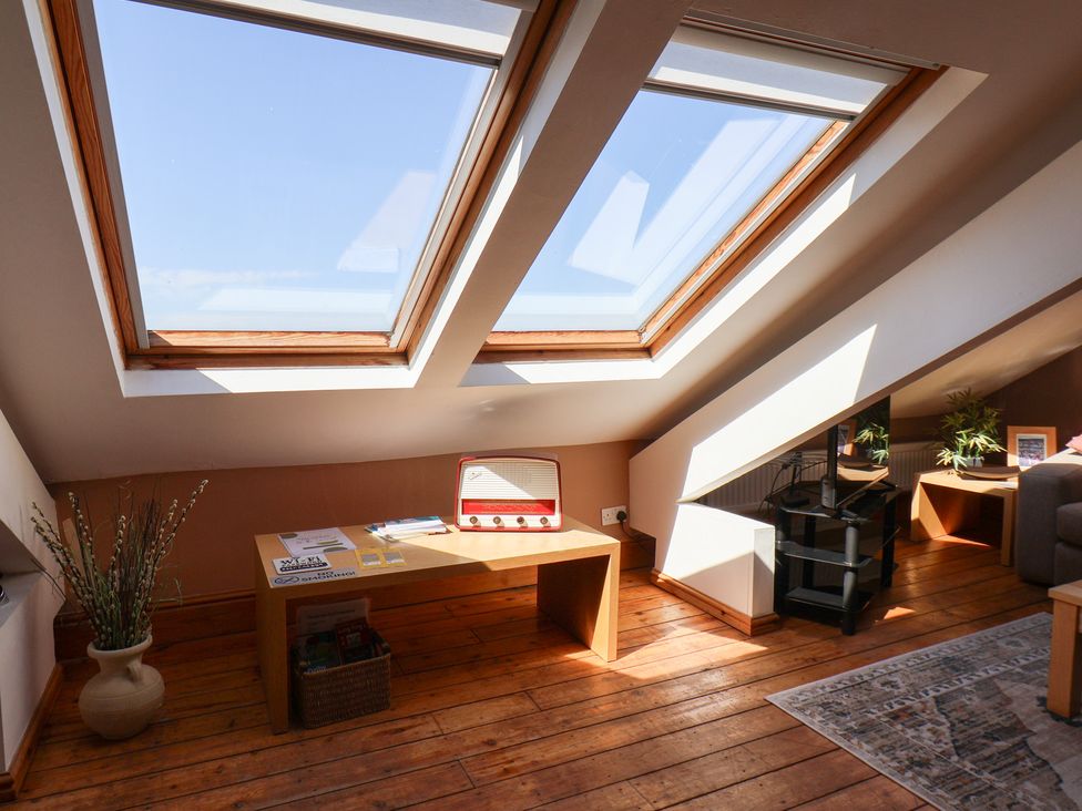 An attic with skylights and a table at The Studio on the Crescent Whitby