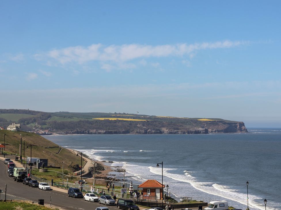 A coastal view with cars parked and the ocean at The Studio on the Crescent in Whitby