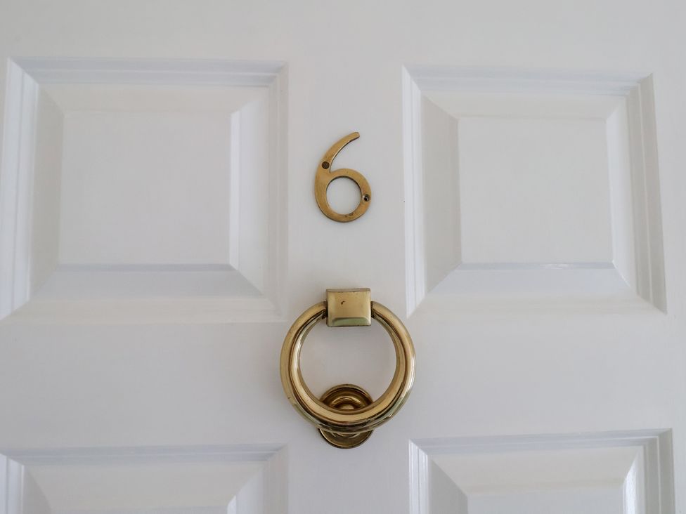A door with number 6 and a knocker at The Studio on the Crescent Whitby