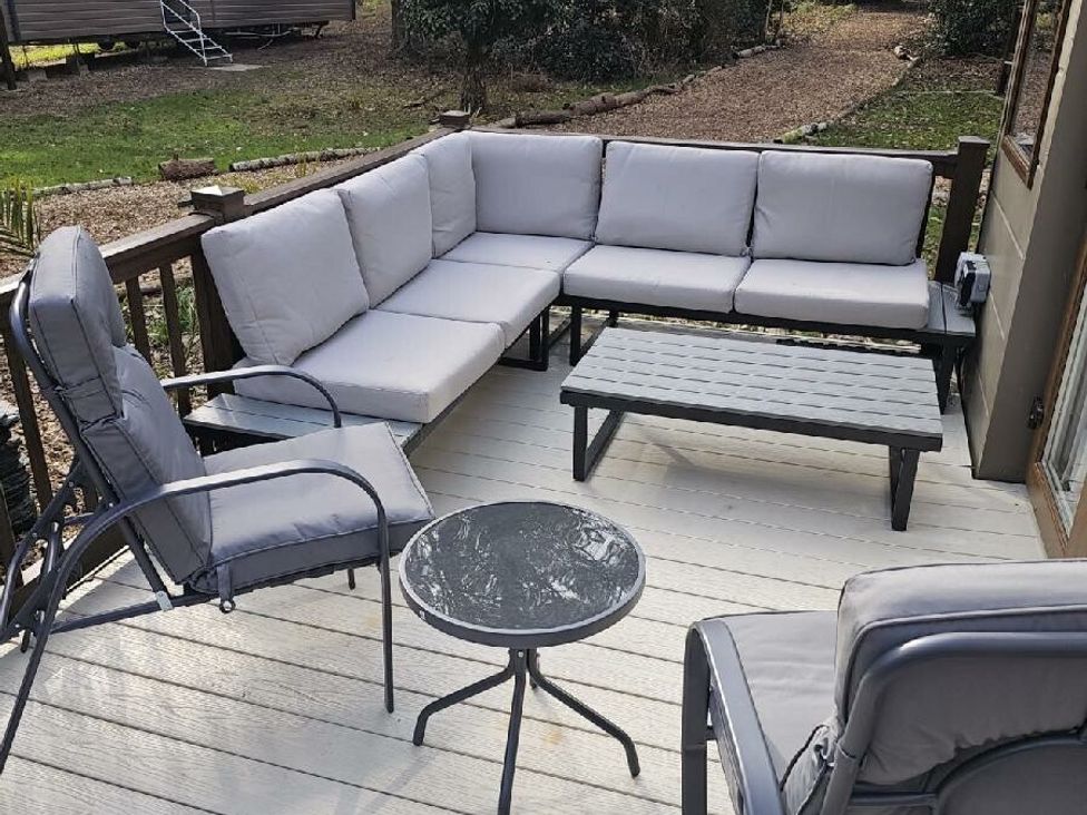 a patio seating area with a sectional sofa and coffee table at Wild Duck Holiday Park - Holiday Accommodation 10389 Nr Great Yarmouth