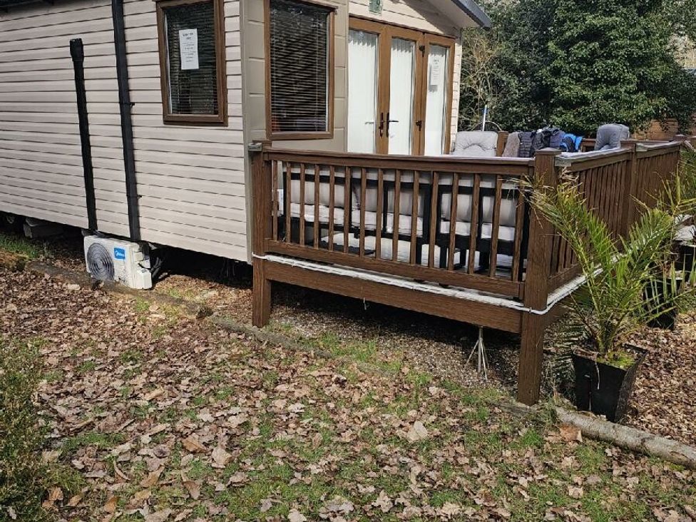 a deck with seating outside a cabin at Wild Duck Holiday Park - Holiday Accommodation 10389 Nr Great Yarmouth