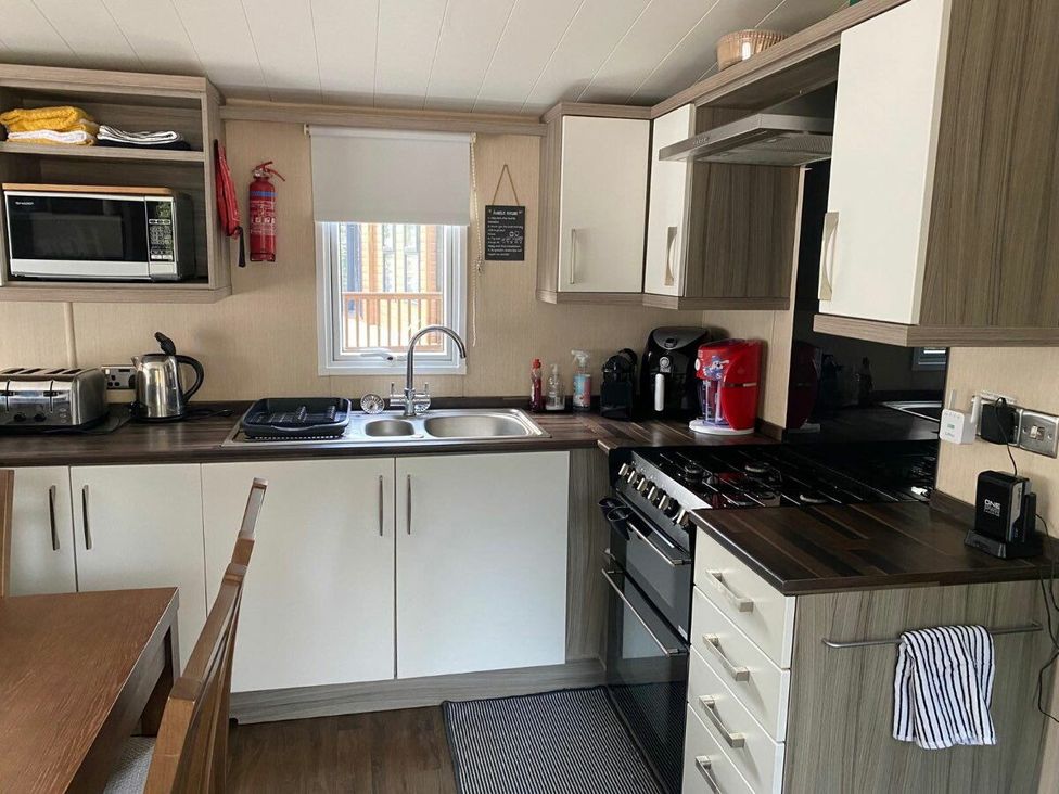 a kitchen with appliances including a microwave, kettle, and coffee maker at Wild Duck Holiday Park - Holiday Accommodation 10389, Nr Great Yarmouth