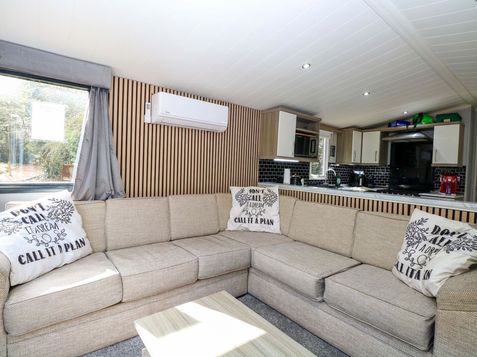 A living room with a sofa and coffee table at Wild Duck Holiday Park in Belton, Norfolk