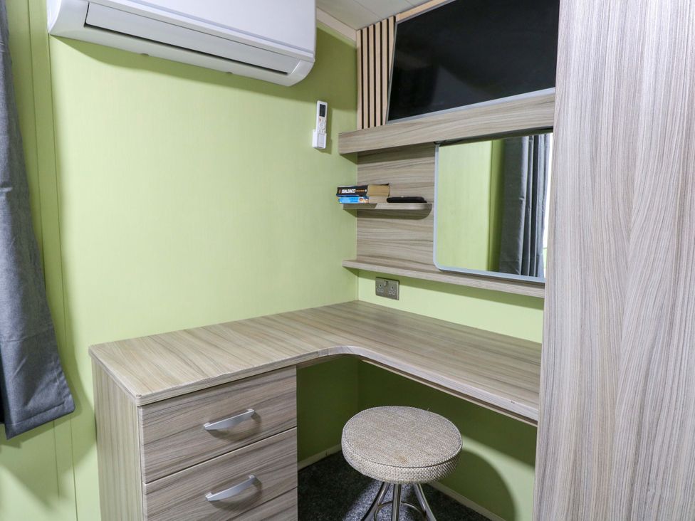 A study area with a desk and mirror at Wild Duck Holiday Park, Belton, Norfolk