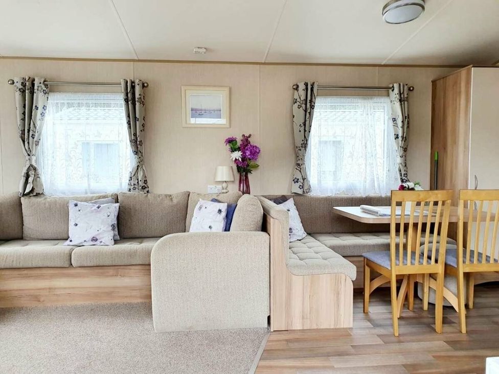 a living room with a sofa and dining area at Shorefield Country Park - Holiday Accommodation 10622 Milford On Sea