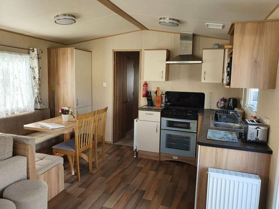 a kitchen and dining area with a table and chairs at Shorefield Country Park - Holiday Accommodation 10622 in Milford On Sea
