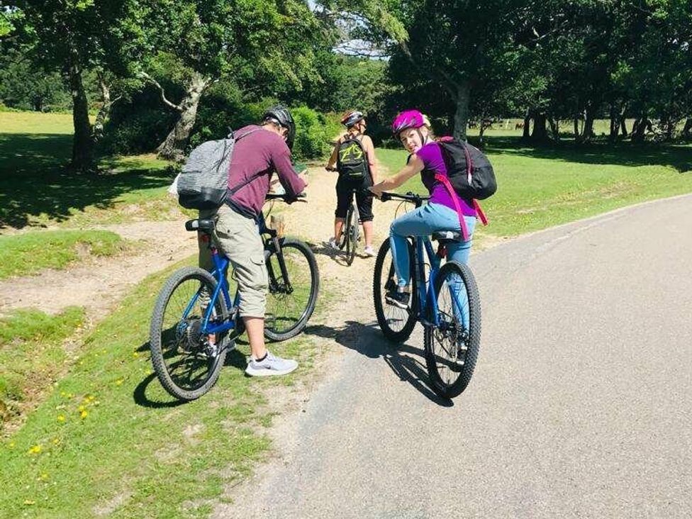 a group of three people on bicycles near a road at Shorefield Country Park - Holiday Accommodation 10622 in Milford On Sea