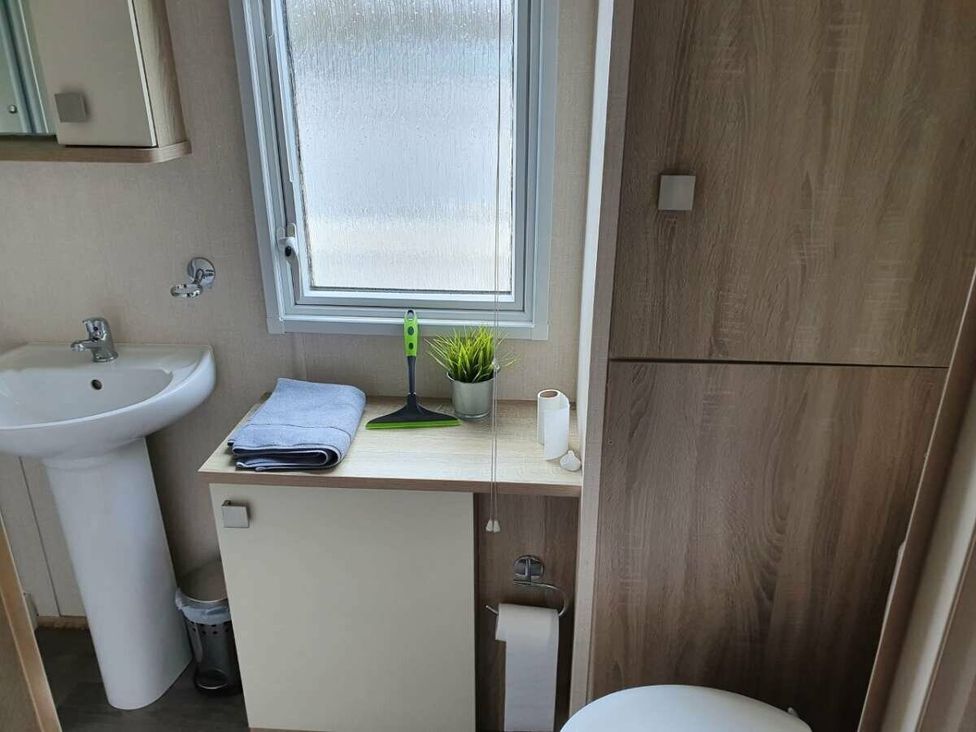 a bathroom with a sink, mirror, and cabinet at Shorefield Country Park - Holiday Accommodation 10821 in Milford On Sea