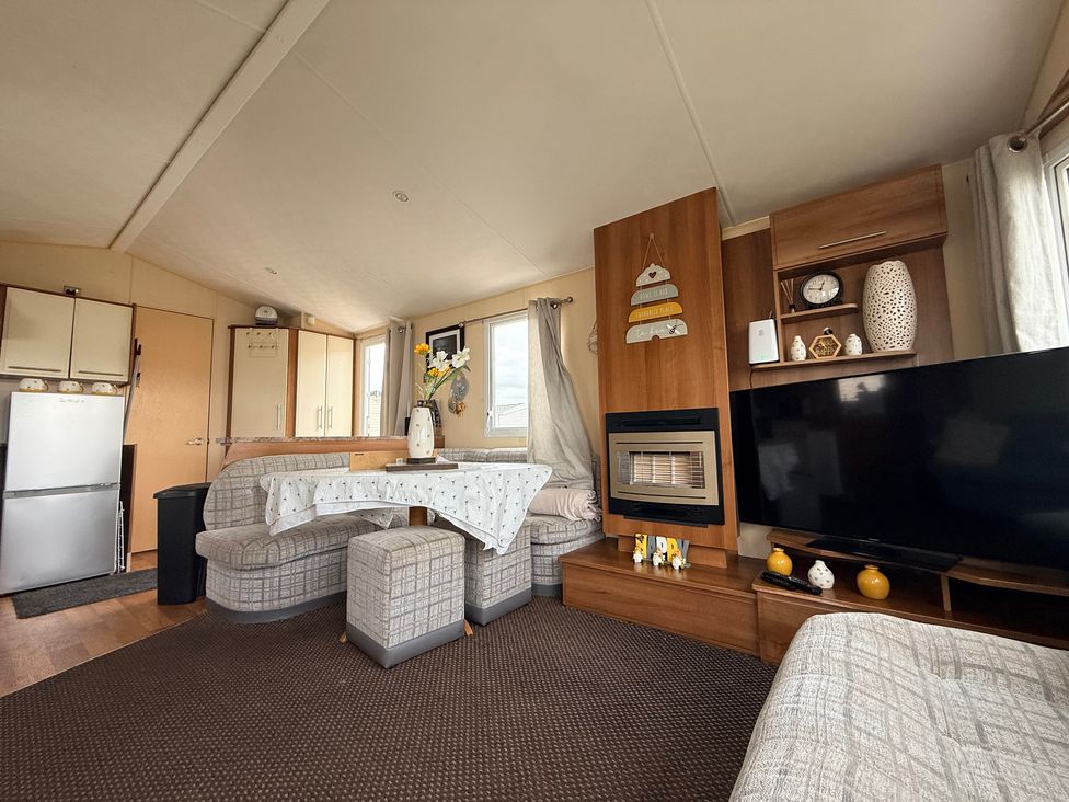 A living room with a sofa and television at Cala Gran Holiday Park - Holiday Accommodation 10830 in Fleetwood