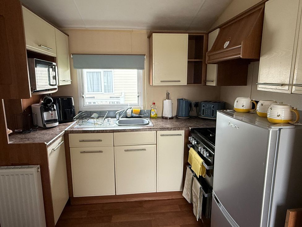 A kitchen with appliances and fixtures at Cala Gran Holiday Park - Holiday Accommodation 10830, Fleetwood