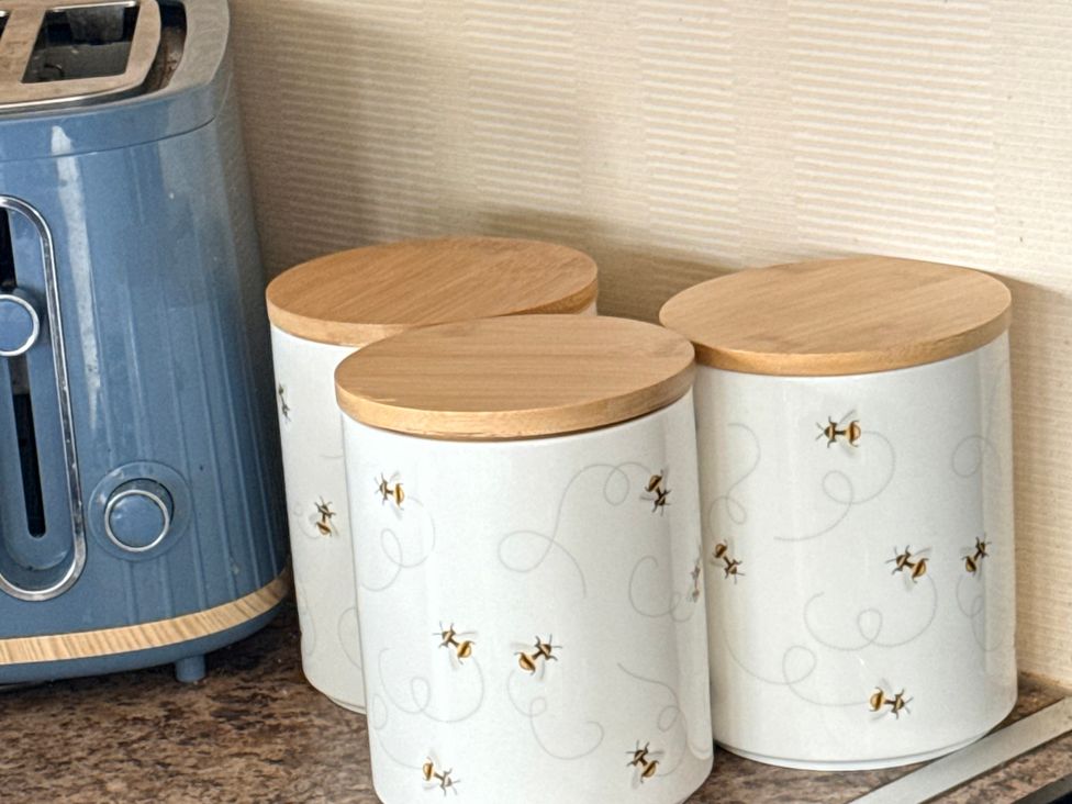 A kitchen with a toaster and storage canisters at Cala Gran Holiday Park - Holiday Accommodation 10830, Fleetwood