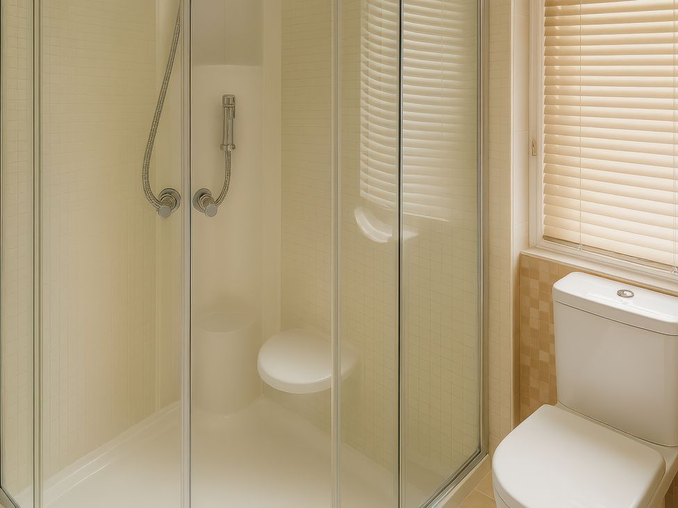A bathroom featuring a shower and a toilet at Combe Haven Holiday Park - Holiday Accommodation 12122, St. Leonards-on-Sea