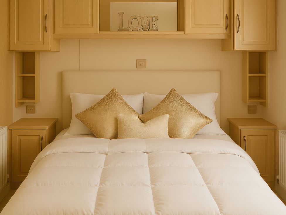 A bedroom with a bed and storage units at Combe Haven Holiday Park - Holiday Accommodation 12122, St. Leonards-on-Sea