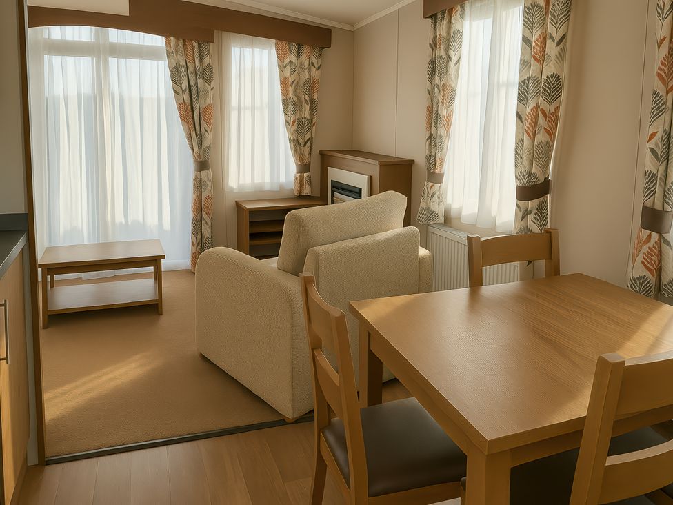 A living room with a sofa and table at Freshwater Beach Holiday Park - Holiday Accommodation 12281, Burton Bradstock