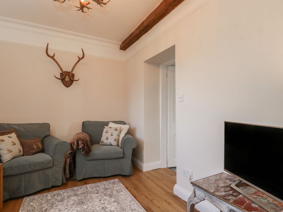 A living room with sofas and a television at Maud Heath's Snug in Chippenham