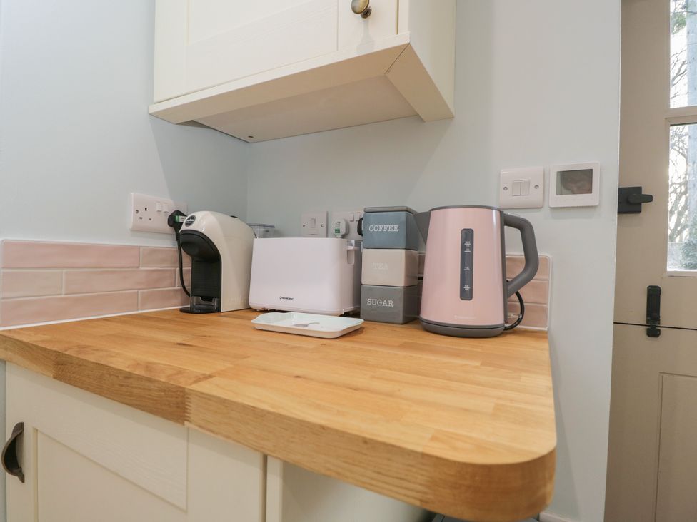 A kitchen countertop with a kettle and coffee machine at Maud Heath's Snug in Chippenham
