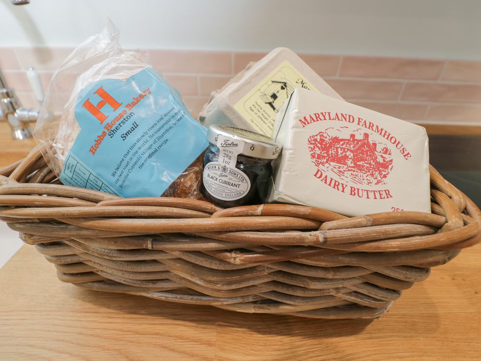 A basket containing bread, butter, jam, and eggs at Maud Heath's Snug in Chippenham