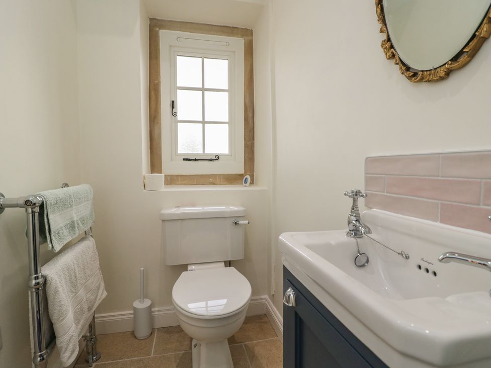 A bathroom with toilet and sink at Maud Heath's Snug in Chippenham
