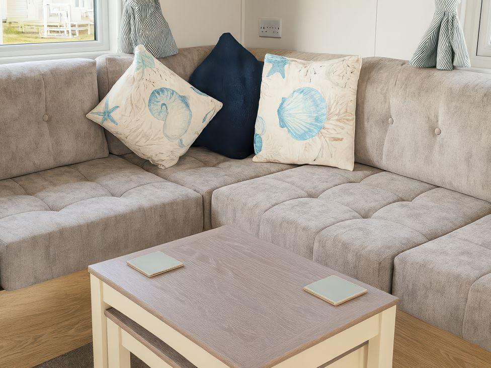 A living room with a sofa and coffee table at Littlesea Holiday Park - Holiday Accommodation 13127 in Weymouth