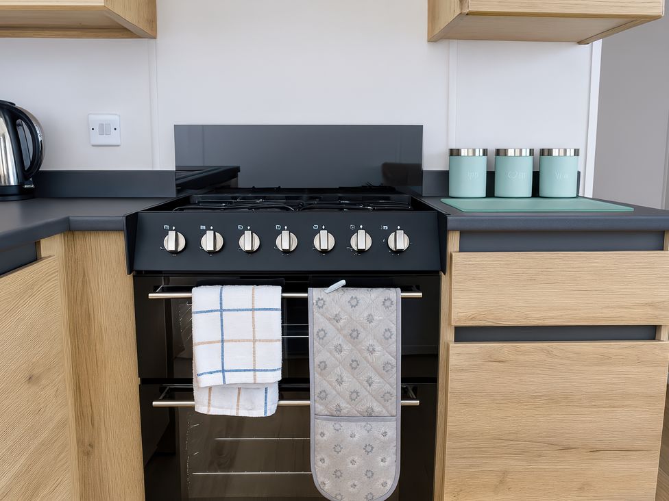 A kitchen with a stove and kettle at Littlesea Holiday Park - Holiday Accommodation 13127 in Weymouth