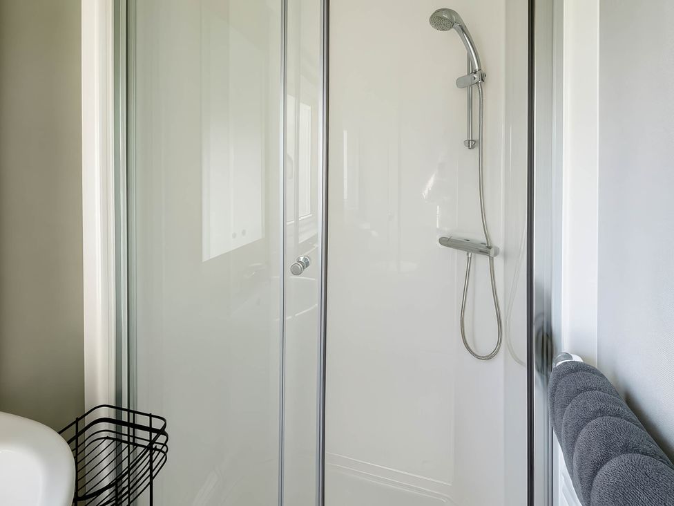 A bathroom with a shower and towels at Littlesea Holiday Park - Holiday Accommodation 13127 in Weymouth