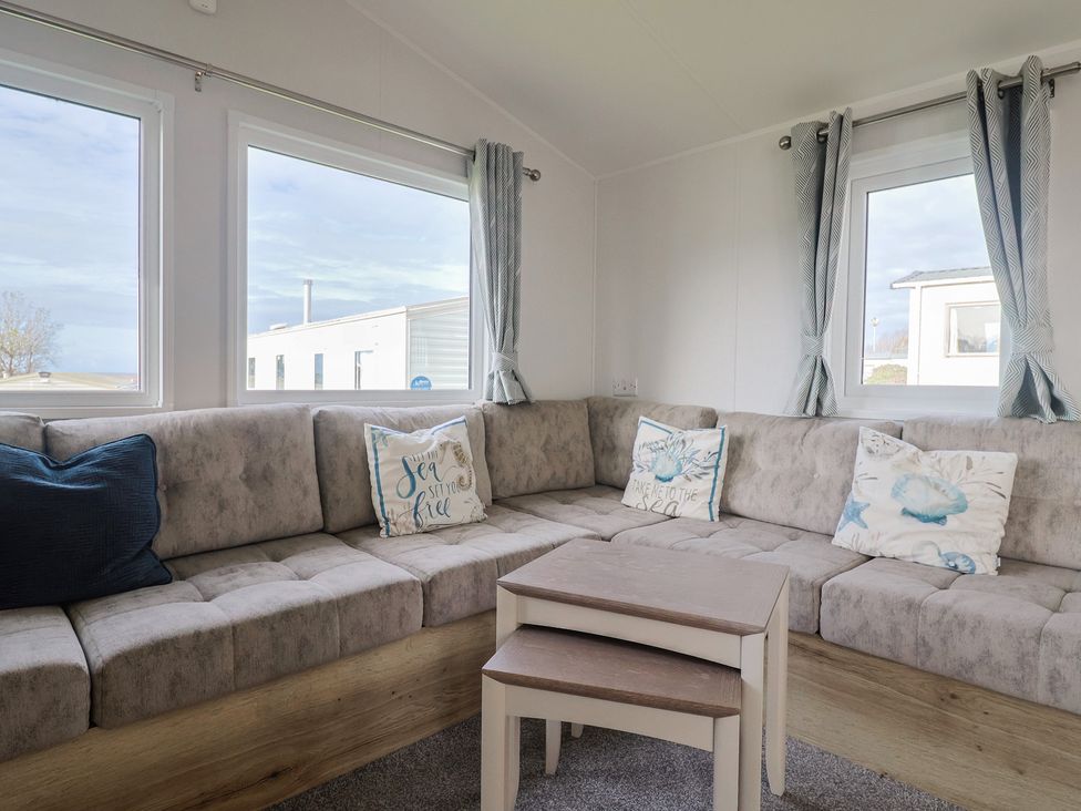 A living room with a sofa and table at Littlesea Holiday Park - Holiday Accommodation 13127 Weymouth