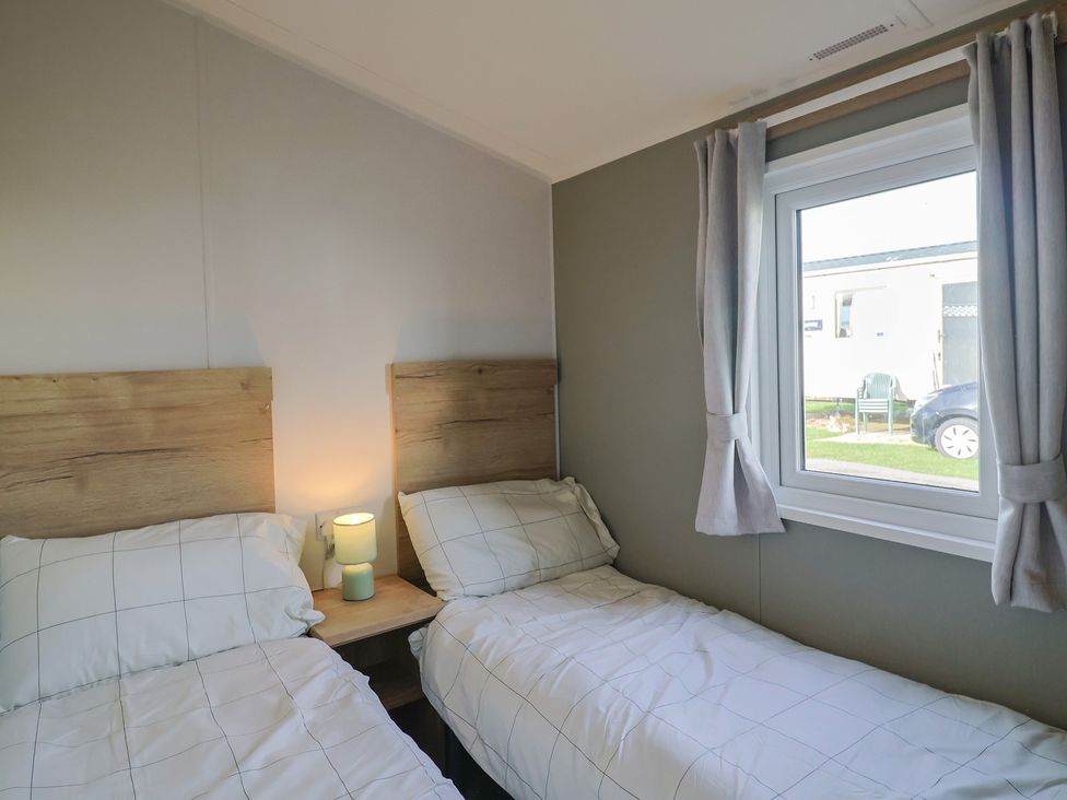 A bedroom with two single beds and a window at Littlesea Holiday Park - Holiday Accommodation 13127, Weymouth