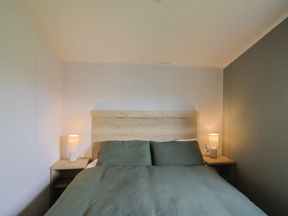 A bedroom with a double bed and bedside tables at Littlesea Holiday Park - Holiday Accommodation 13127 in Weymouth