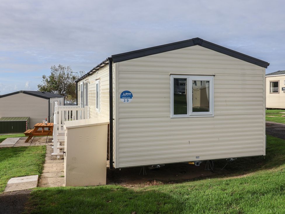 A mobile home with steps and grass at Littlesea Holiday Park - Holiday Accommodation 13127 Weymouth