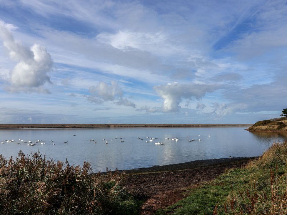 A body of water with swans at Littlesea Holiday Park - Holiday Accommodation 13127 in Weymouth