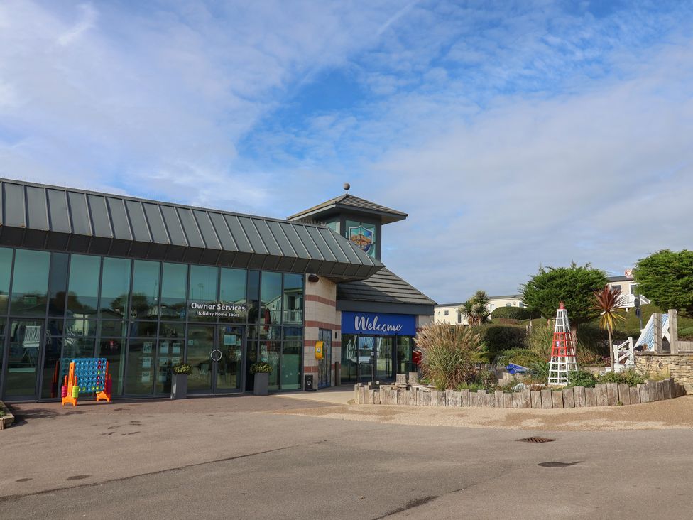 An outdoor area with a building and landscaping at Littlesea Holiday Park - Holiday Accommodation 13127 Weymouth