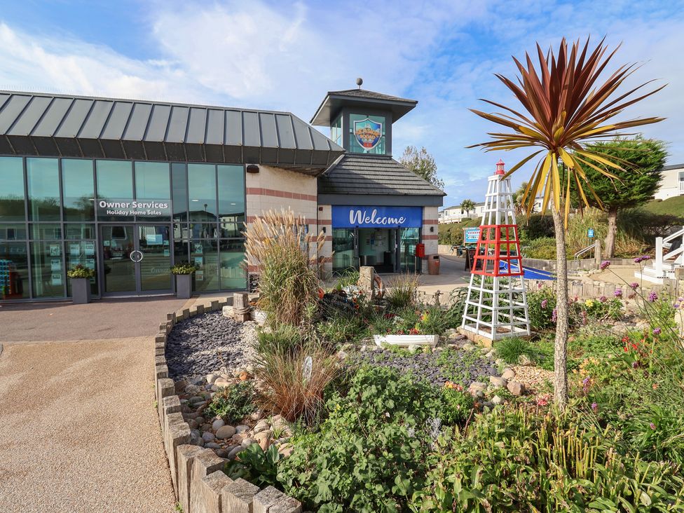 An outdoor area with a welcome sign and landscaped garden at Littlesea Holiday Park - Holiday Accommodation 13127, Weymouth