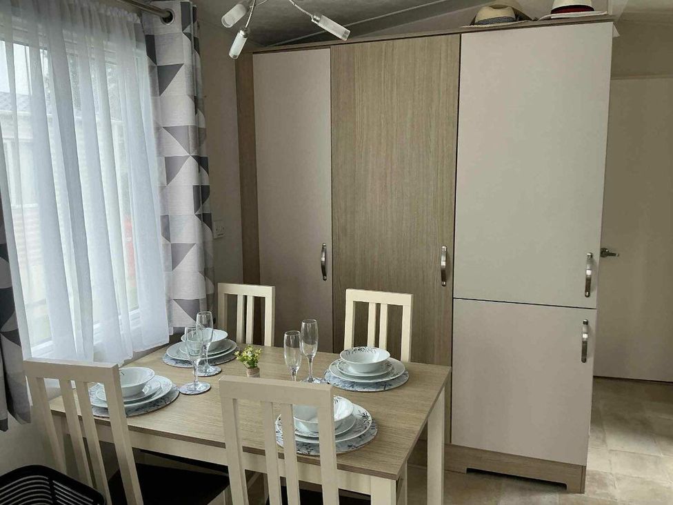 a dining area with a table set for four at Golden Palm Resort - Holiday Accommodation 13363, Skegness