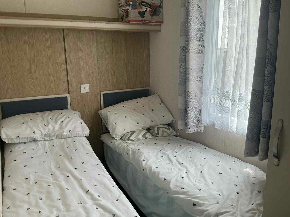 a bedroom with two single beds and a window at Golden Palm Resort - Holiday Accommodation 13363, Skegness