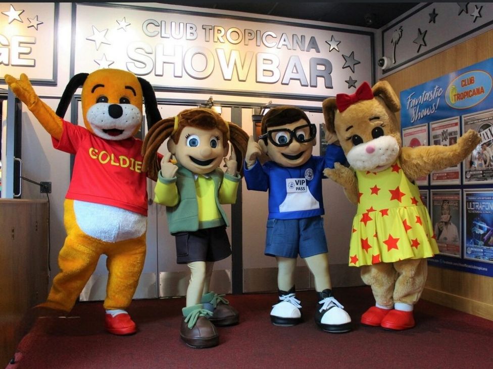 four cartoon mascots posing in a showbar entrance at Golden Palm Resort - Holiday Accommodation 13363, Skegness
