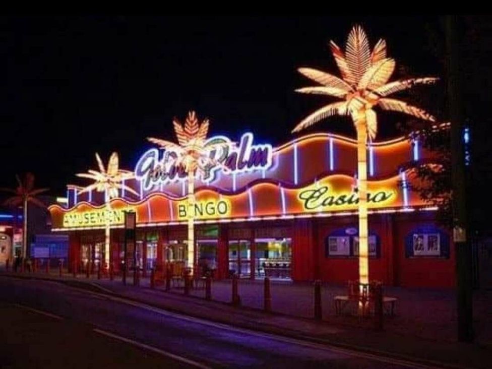 a brightly lit building with palm tree decorations at Golden Palm Resort - Holiday Accommodation 13363 Skegness