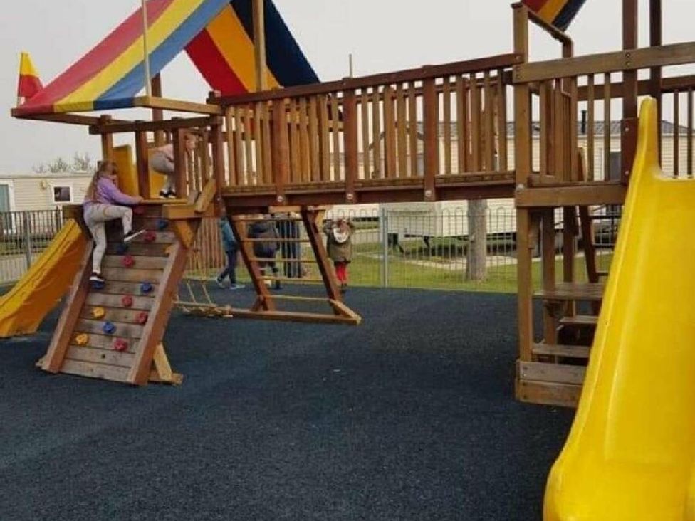 a playground structure with climbing walls and a slide at Golden Palm Resort - Holiday Accommodation 13363, Skegness