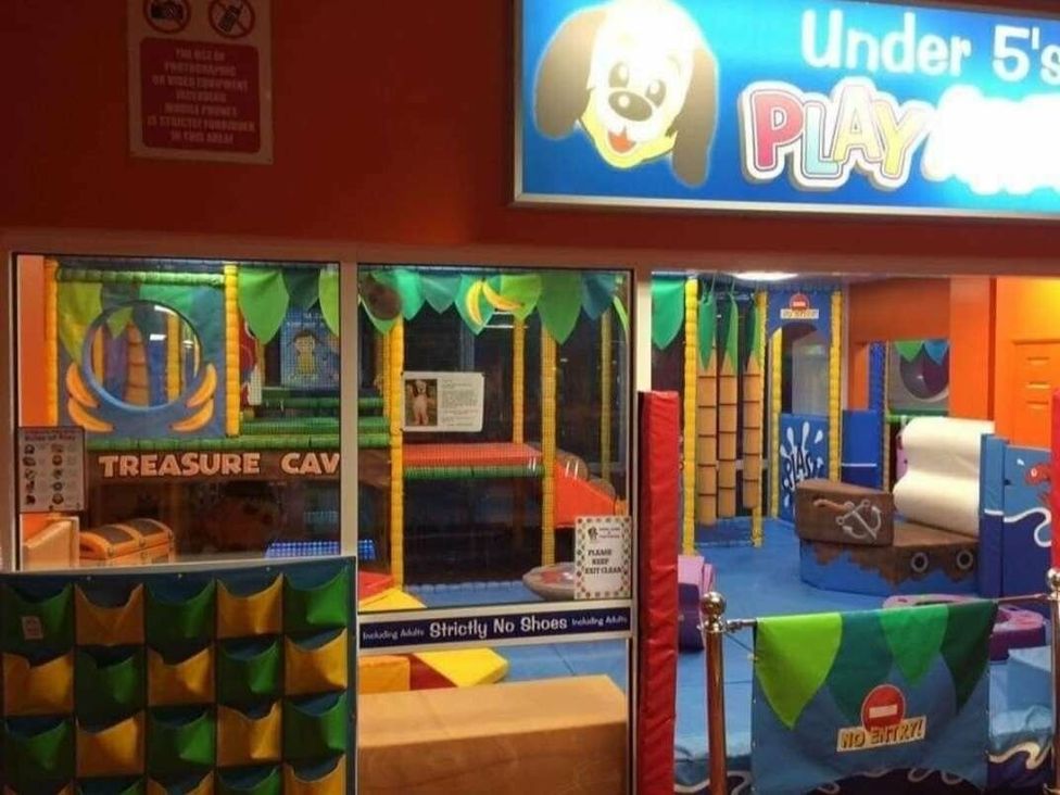 a play area with colorful structures and soft surfaces at Golden Palm Resort - Holiday Accommodation 13363, Skegness