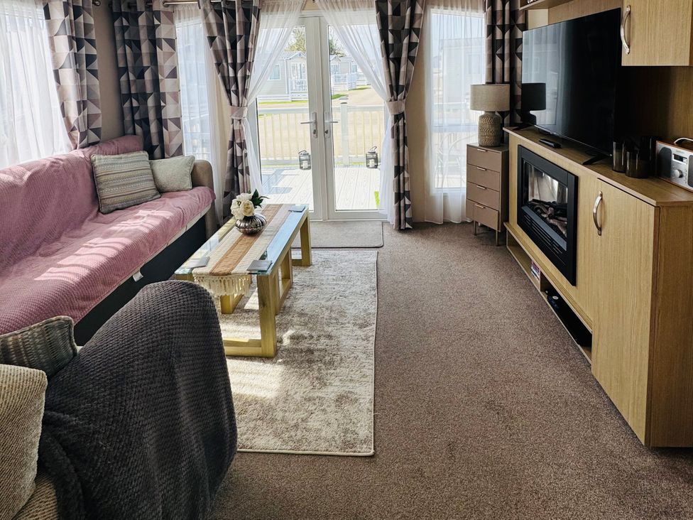 A living room with a sofa, coffee table, and TV at Golden Palm Resort - Holiday Accommodation 13363 in Skegness
