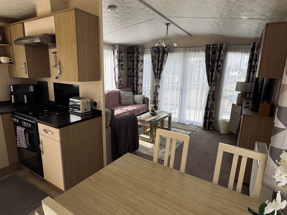 A kitchen and living room area with appliances and furnishings at Golden Palm Resort - Holiday Accommodation 13363, Skegness