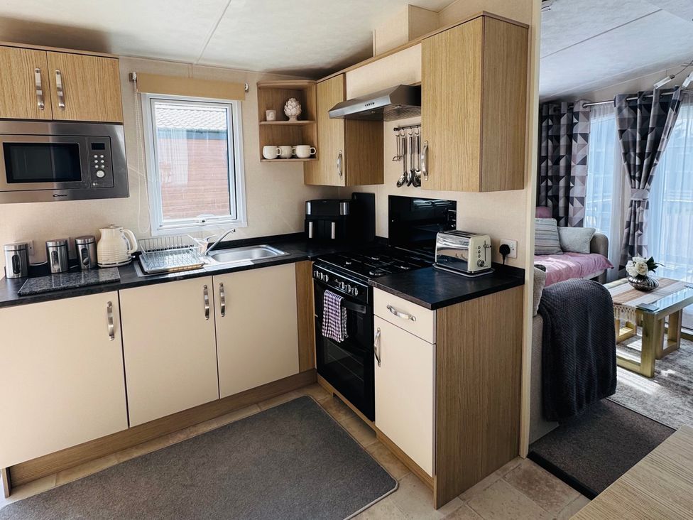 A kitchen with cabinets and appliances at Golden Palm Resort - Holiday Accommodation 13363 Skegness