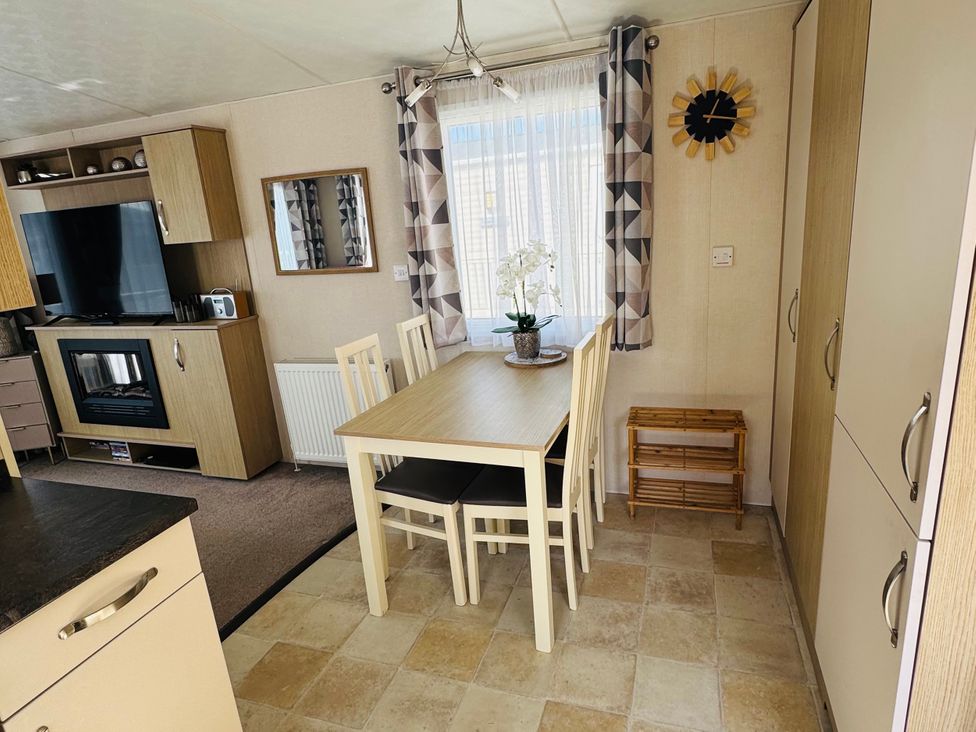 A dining room featuring a table and chairs at Golden Palm Resort - Holiday Accommodation 13363 Skegness